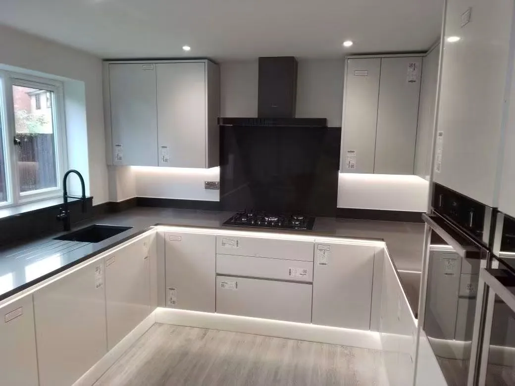 Jamie’s kitchen installation with fitted cabinets, dark worktops and a sink